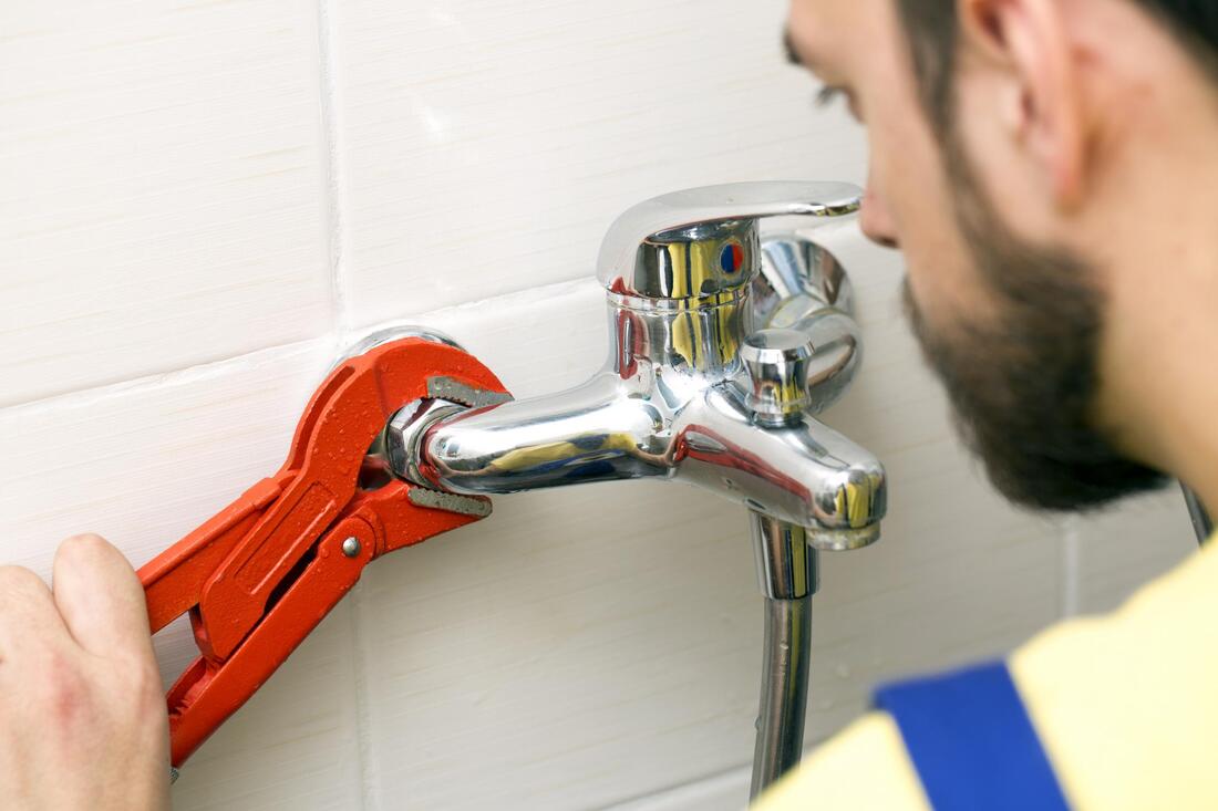 man fixing a sink