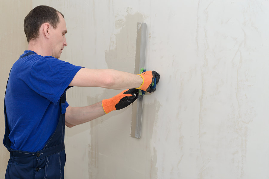 man polishing a wall