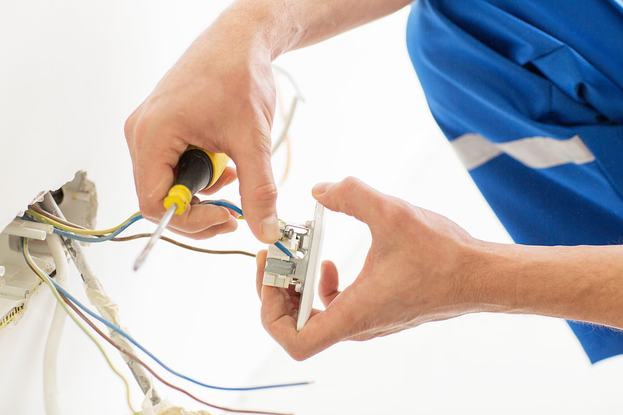 man fixing an electric socket