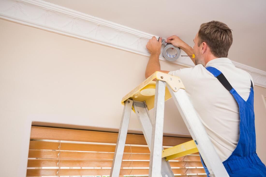 man fixing a ceiling